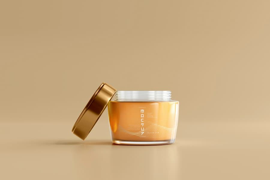 An open amber glass jar with a brushed gold lid resting beside it
